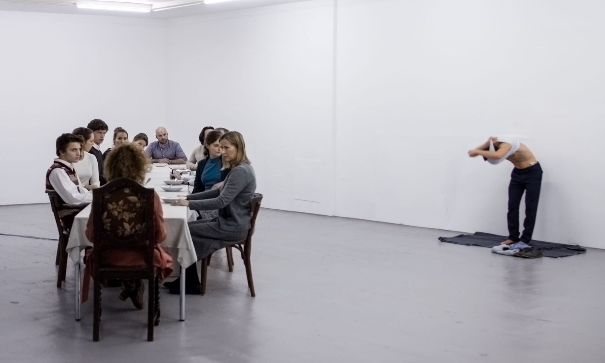 Lange Tafel mit vielen Sitzenden im hellen Raum